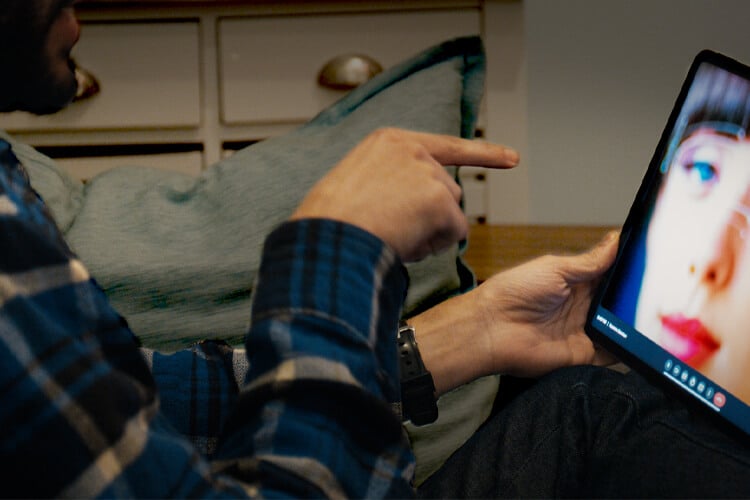 Colorist in suite with client on remote screen